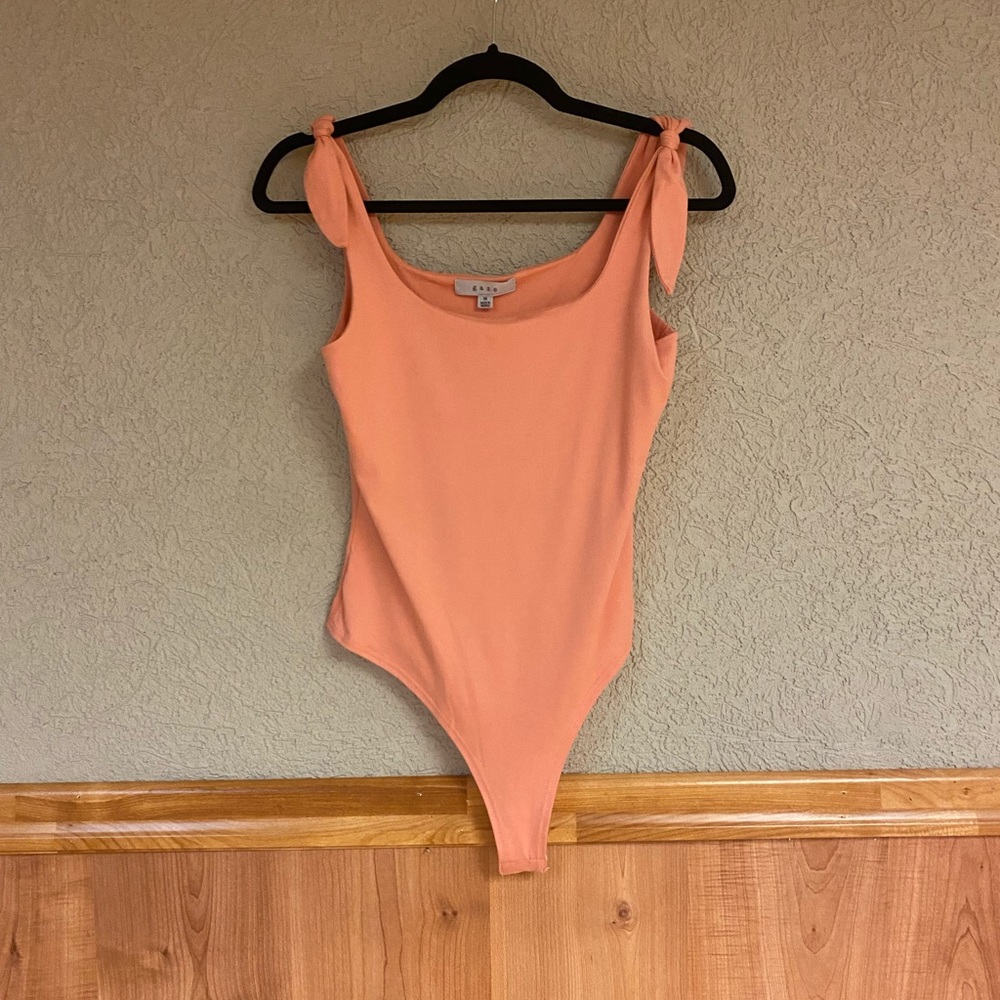 Tie straps body suit. Never worn